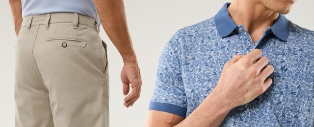 Ein Mann trägt eine beige Chinohose und dazu ein blau gemustertes Poloshirt. Der Look ist modern und wirkt gepflegt und sommerlich.