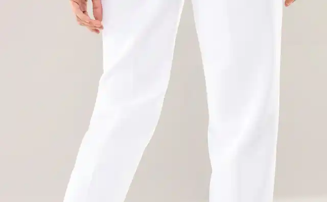 Person trägt eine weiße Hose und schwarze Schuhe, fotografiert von hinten. Der Hintergrund ist neutral gehalten.